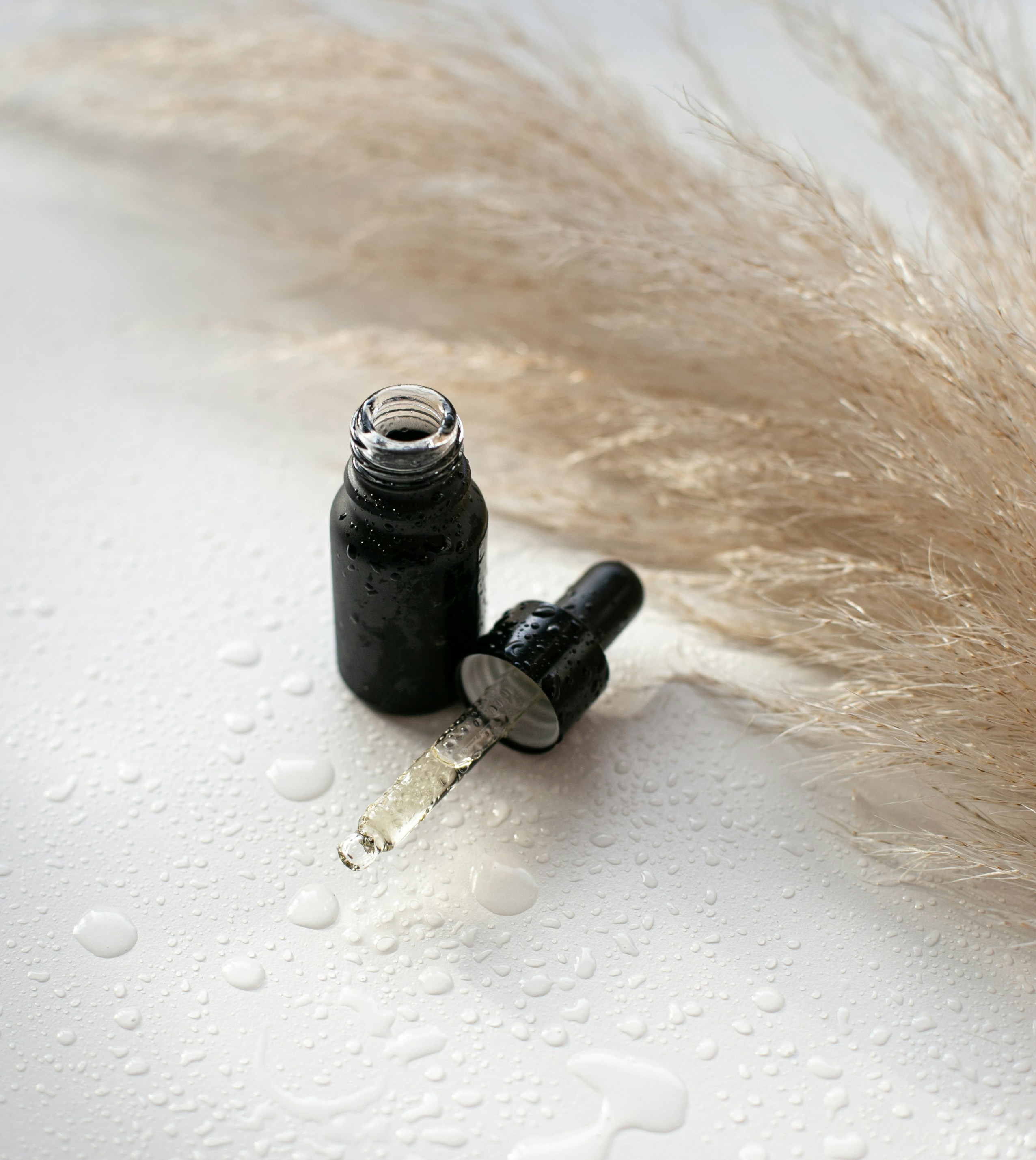 Skincare serum and product textures on a neutral background